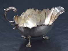 A late Victorian silver sauce or gravy boat of canted traditional design, with Chippendale scroll