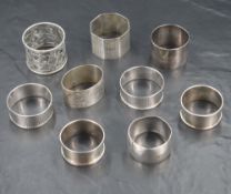 An assortment of early 20th century silver napkin rings (8), including some having engine turned