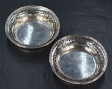 A pair of George VI silver dishes, of circular form having banding to the rim and pierced conforming
