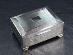 An Elizabeth II silver cigarette box, of hinged rectangular form with engine turned decoration and