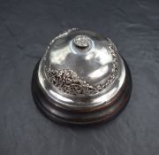 An early 20th century silver mounted mechanical desk bell, having embossed and pierced floral