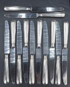 A set of twelve Elizabeth II silver handled table knives, having unmarked blades and a moulded