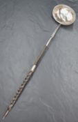 A George III silver and Baleen toddy ladle of traditional form with beaded rim and bright cut
