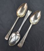 A pair of George III silver Old English spoons, old along with a single silver George III spoon of