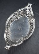 A late Victorian silver dish of rounded lozenge form, having lobed sides, central engraved