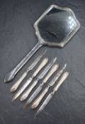 A cased set of six George V silver-mounted dessert or fruit knives, the moulded handles having Art