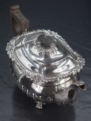 An Edwardian silver teapot, of squat baluster form, having a conforming lobed top with gadrooned and