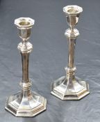A pair of Elizabeth II silver candlesticks, of turned octagonal form having octagonal scones, raised