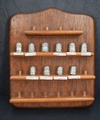 A group of ten silver thimbles with offices and dates labelled to stand, various makers and dates,
