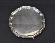A large Elizabeth II silver salver, of shaped circular form having Chippendale influenced design