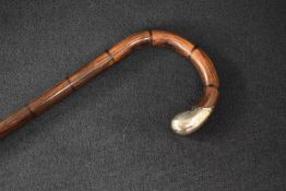 A late Victorian silver mounted walking stick, the bamboo cane with curved handle finishing with a