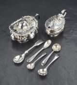 An Edwardian silver condiment pot having egg and dart rim with embossed scroll work to cover and
