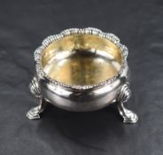 A George III silver salt, of traditional form with lobed textured rim, raised three cabriole legs,