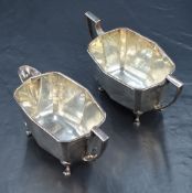 A 1930s silver sugar and cream, having geometric and canted rectangular bodies with angular handles,