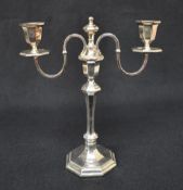 An Elizabeth II silver two-branch candlestick, of turned and octagonal form, the central columns