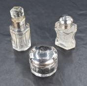 Three silver topped and mounted glass dressing tablewares, including two perfume bottles and a