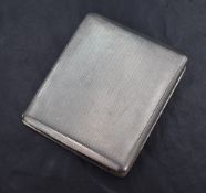 A George VI silver cigarette case of hinged square form, having engine turned decoration, marks