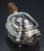A George III silver tea pot, of squat rounded rectangular form, having slightly flared egg and