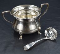 An early 20th century silver sugar bowl of bulbous form, having a flared rim and angular handles,