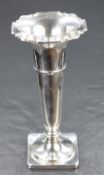 A George V silver vase, of flared cylindrical form having a Chippendale inspired rim on with a