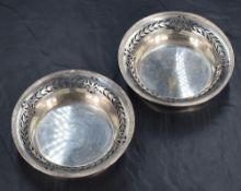 A pair of George VI silver dishes, of circular form having banding to the rim and pierced conforming