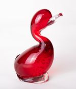 A Whitefriars glass controlled bubble and cased ruby red Dilly Duck, designed by Geoffrey Baxter,