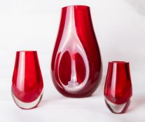 A large Whitefriars glass cased ruby red dimpled teardrop vase, designed by Micheal Cripps,