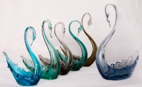 A group of six Whitefriars glass swans, small, medium and large in blue, ocean green, Arctic blue