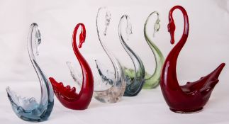 A group of six Whitefriars glass swans, small and medium in blue, Arctic blue, ruby red, ocean green