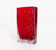 A Whitefriars glass ruby red and clear glass textured and bow-fronted Nailhead vase, designed by