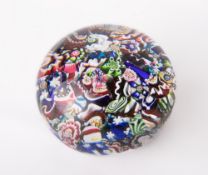 A 19th century end of day scrambled millefiori paperweight, of typical domed circular form with a