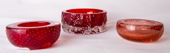 A 1960s Whitefriars glass bark textured dish in cased ruby red, designed by Geoffrey Baxter,
