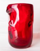 A large 1960s Whitefriars glass 'Knobbly' vase in ruby red, designed by William Wilson and Harry
