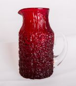 A Whitefriars glass ruby red textured whisky water jug, designed by Geoffrey Baxter, catalogue