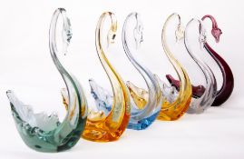 A group of six Whitefriars glass swans, small in flint, amber, amethyst, ocean green and Arctic blue
