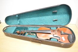 A traditional violin having 13 inch two piece back, with hard case, with printed label J G