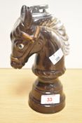 A 20th Century treacle glazed table top lighter in the form of a horse's head or chess piece,