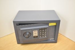 A safe with electronic keypad and instructions.