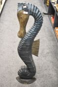 A 20th Century stylish carved wooden seahorse floor standing study, measuring 102cm high