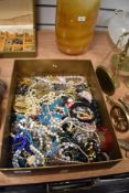 A large assortment of costume jewellery including beaded necklaces, brooches, bangles, statement