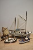 A group of four 20th Century hand crafted boat ornaments, painted in various colours, the largest