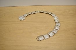 An Art Nouveau silver plated articulated belt and buckle, each square panel cast with a cherubs