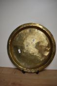 A Chinese brass charger, with engraved traditional design, having a diameter of 50cm