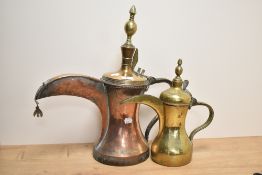 Two 19th/20th Century Arabic Dallah coffee pots, in copper and brass, the largest measures 50cm
