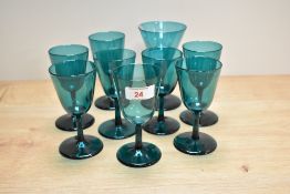 A selection of mid-20th Century deep green coloured glasses, the largest measures 14cm high