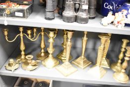 Four pairs of 19th Century brass candlesticks, the largest measure 29cm high, two three branch