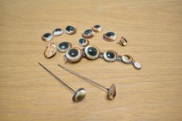 A group of operculum shell cabochons, some set in a broken bracelet, a single stud earring and two