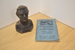 A vintage Insurance Bill Bank moneybox (AF) and a Vanguard Pocket stamp album with contents.