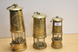 A 20th Century brass Eccles Type 6 miner's lamp, measuring 27cm high, together with two other