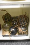 A collection of nine glass fishing floats.